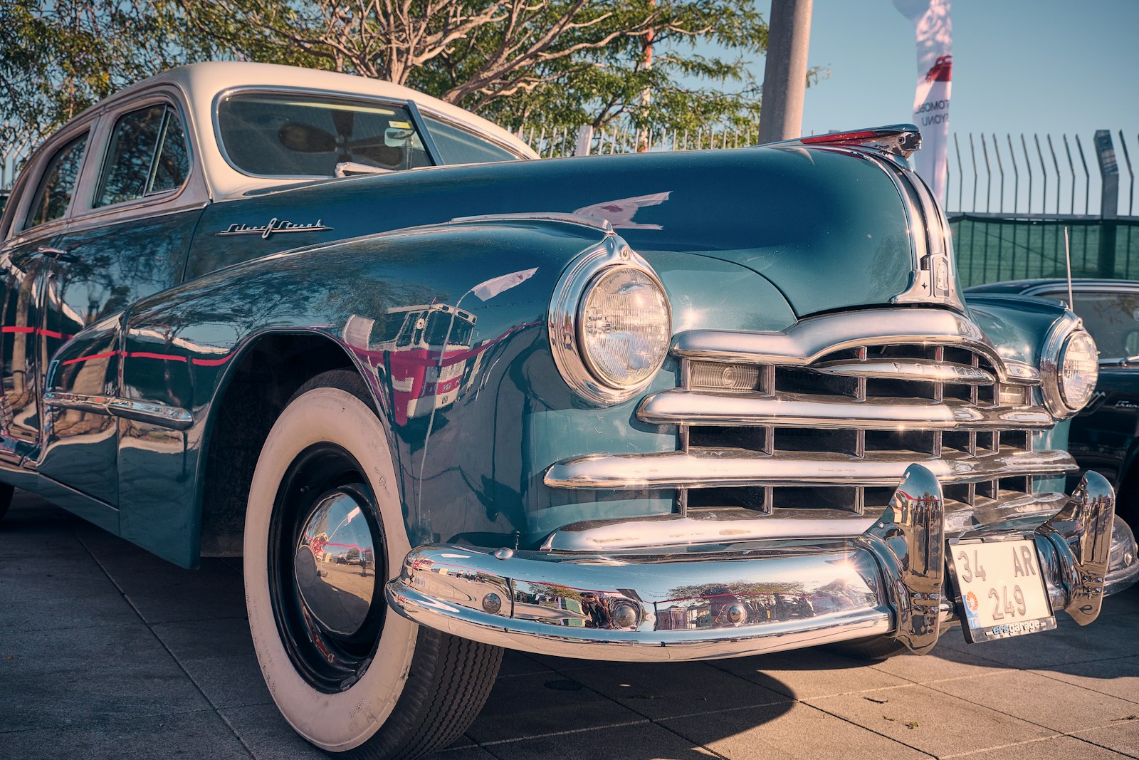 a classic car parked on the side of the road, auto